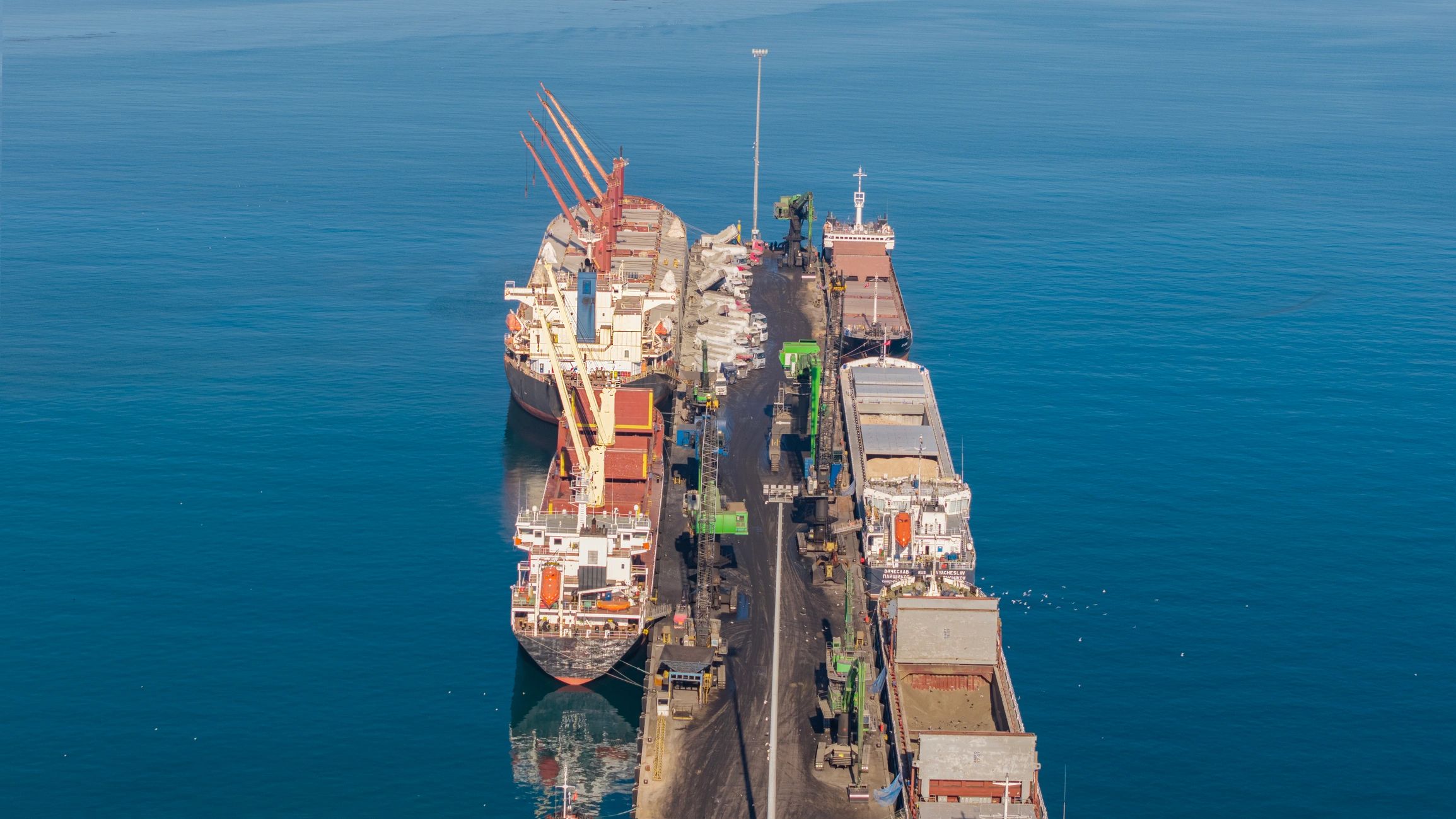 Aerial view of vessels alongside an industrial port terminal