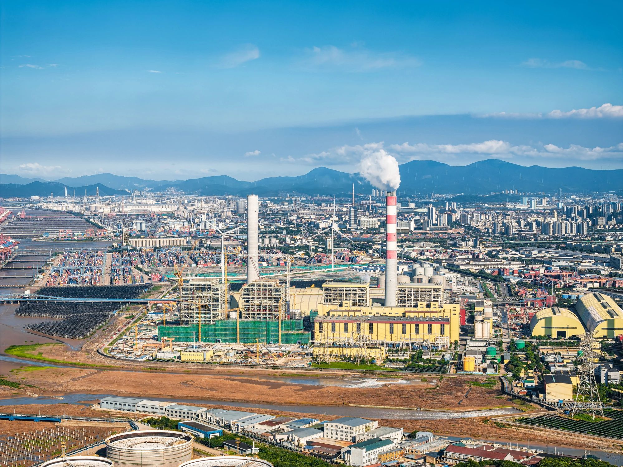 Industrial port area with energy infrastructure and skyline
