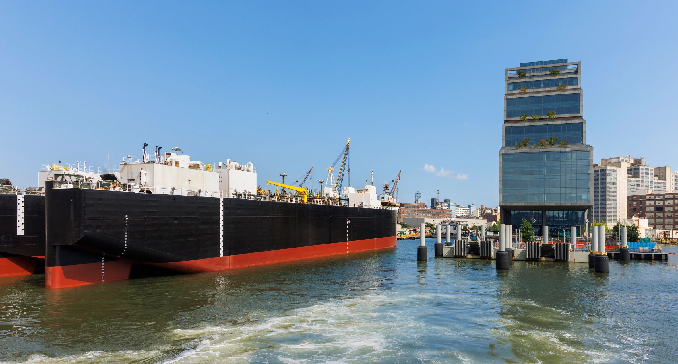 Industrial cargo ship moored at a pier on a clear day